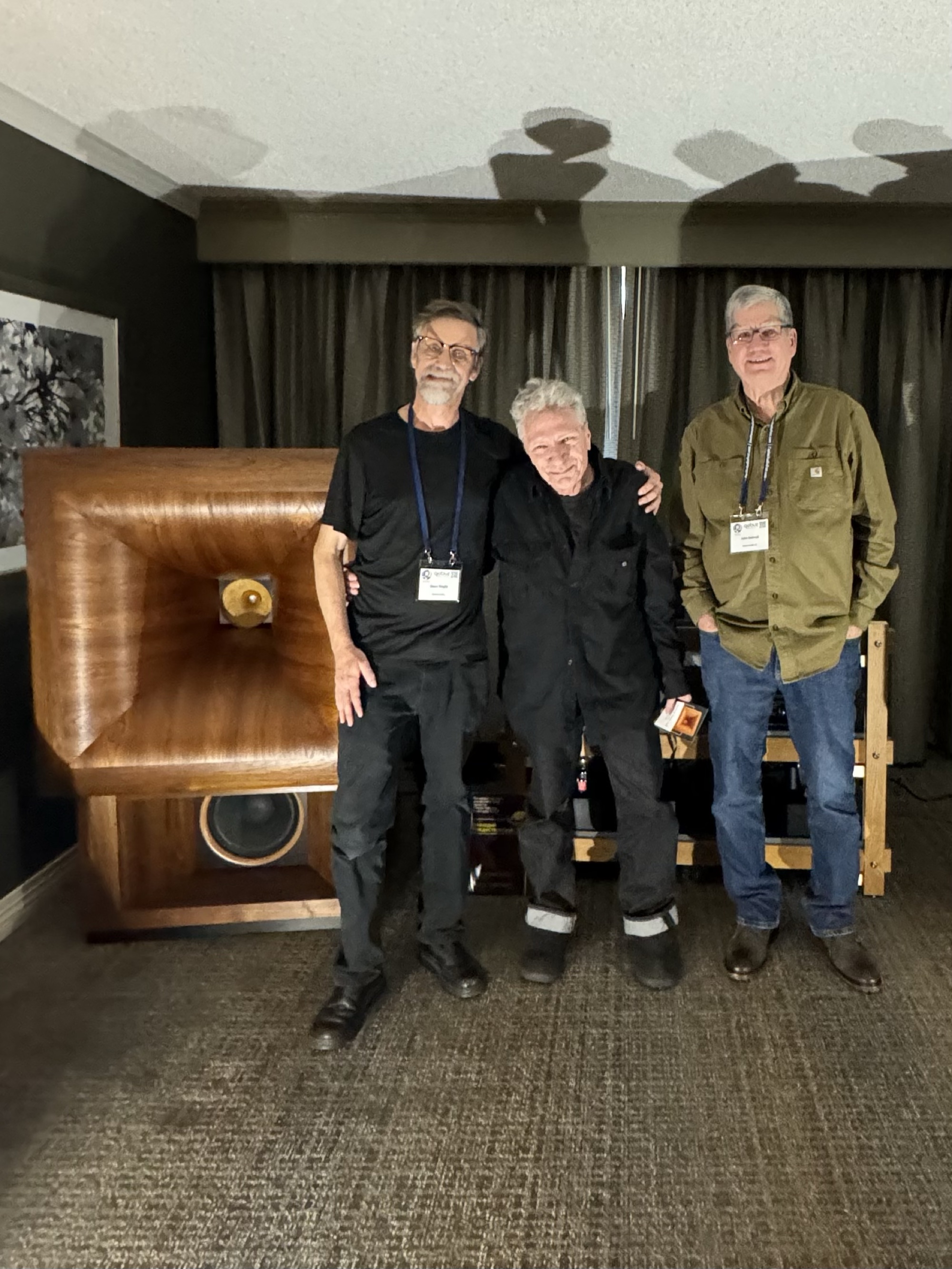 Dave Slagle, Herb Reichert, and John Semrad standing beside a Semrad Audio horn speaker at an audio show.